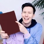 Phil Lester holding up a sign