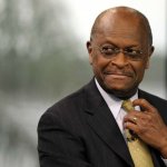 Herman Cain adjusting tie