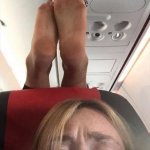 Feet on seat of airplane