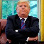 Trump arms folded frowning