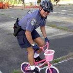 Cop on little bike