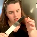 Girl examining knife
