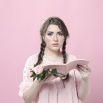 woman-holding-roses-impressed-by-book
