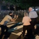 Protester flipping off old couple