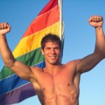 gay guy in front of flag