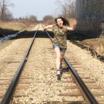 girl running on train tracks