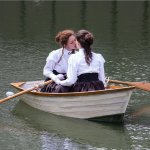 Two girls kissing on a boat