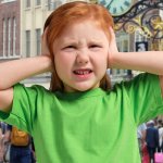 GIRL HANDS OVER EARS GINGER KID