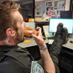 Cop Eating Donut with Feet on Desk