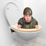 Coward hiding in toilet  Army helmet
