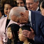 Joe Biden sniffs Chinese child