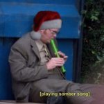 Dwight playing somber song santa hat