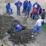 single worker digging hole