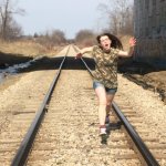 girl running on train tracks