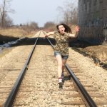 girl running on train tracks