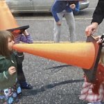 Girl yelling at her sister in a cone