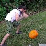 Charlie beating up a pumpkin with a bat