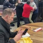 Guy eating during chaos