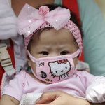 Asian Baby In Hello Kitty Face Mask
