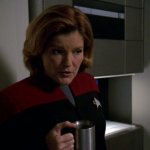 Serious Janeway drinking coffee