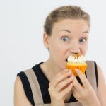 Woman eating cupcake