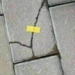 Brick held with a yellow tape