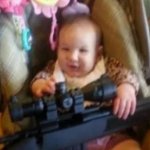 Baby Holding Rifle