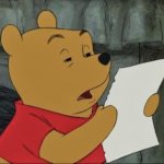 Pooh squinting at paper