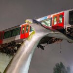 Whale sculpture holding train