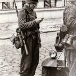 German soldier looking at Smartphone