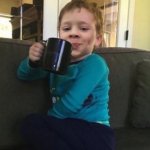 Smug kid with coffee cup on couch