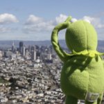kermit looking over a city