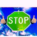 Green stop sign thumbs up