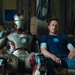 Iron Man 3 Tony Stark sitting next to Mark 42 suit
