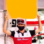 Kimi holding a sign