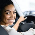 black woman smiling in car