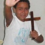 kid holding cross