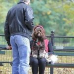 Dog faced person sitting on bench