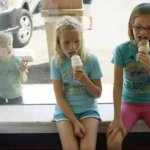 Girls eating ice cream cones boy envious