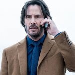 Keanu on mobile phone looking unhappy
