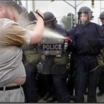 Police spraying fat guy