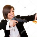 Woman holding goldfish pointing gun at it