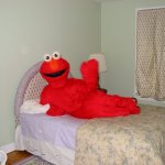 Elmo laying on bed
