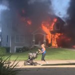Woman with stroller burning house