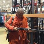 Buddhist priest with barrel gun