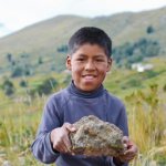 Boy holding a rock