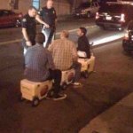 three men riding on coolers? pulled over by the cops