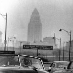 Photo taken by Allan Grant for Life Magazine. | Driving with a gas mask through smog [Los Angeles, 1954, Uncolorized] | image tagged in gas mask driver,los angeles,car,gas mask,driving,historical meme | made w/ Imgflip meme maker