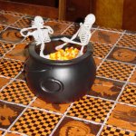 Two skeletons in candy corn hot tub