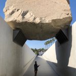 man under boulder